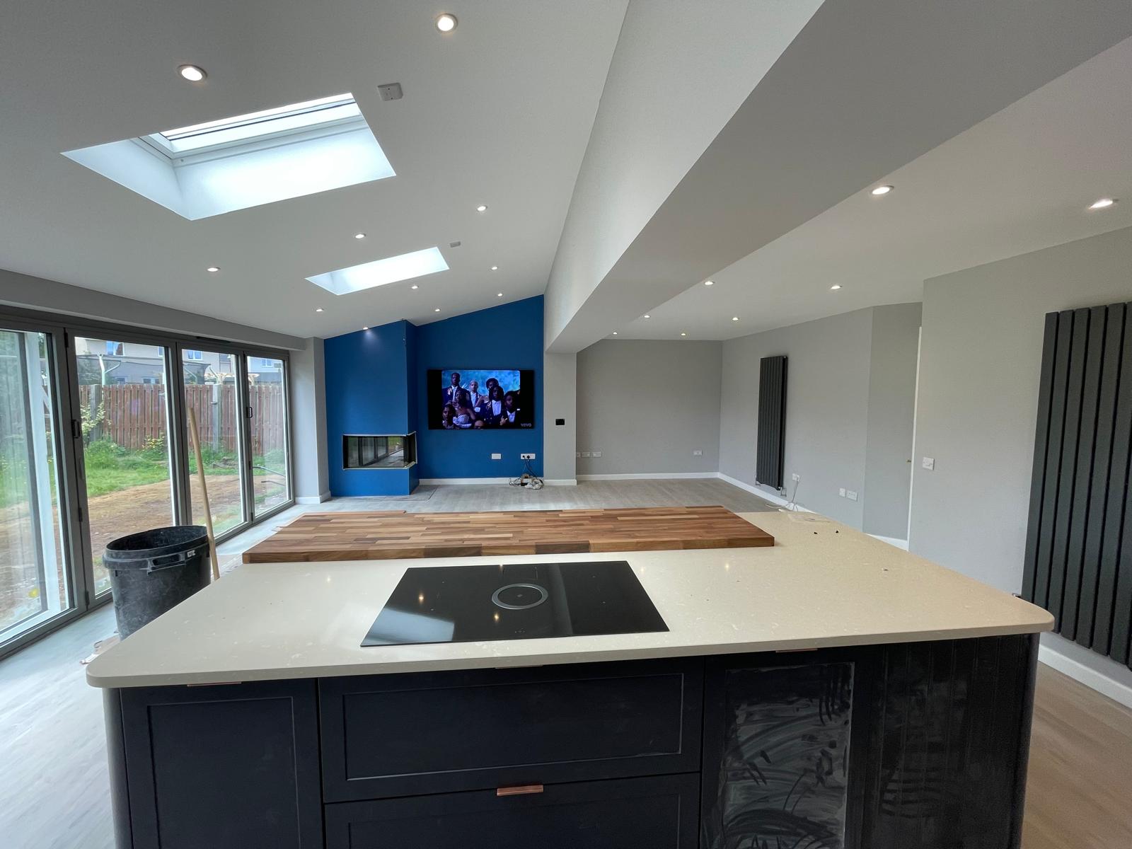 Modern extension kitchen with blue feature wall