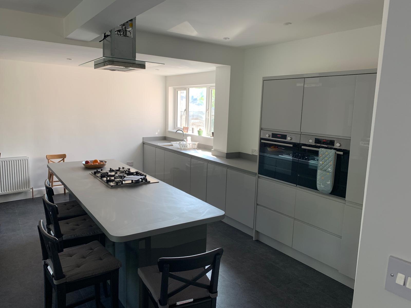 Grey galley kitchen with island seating