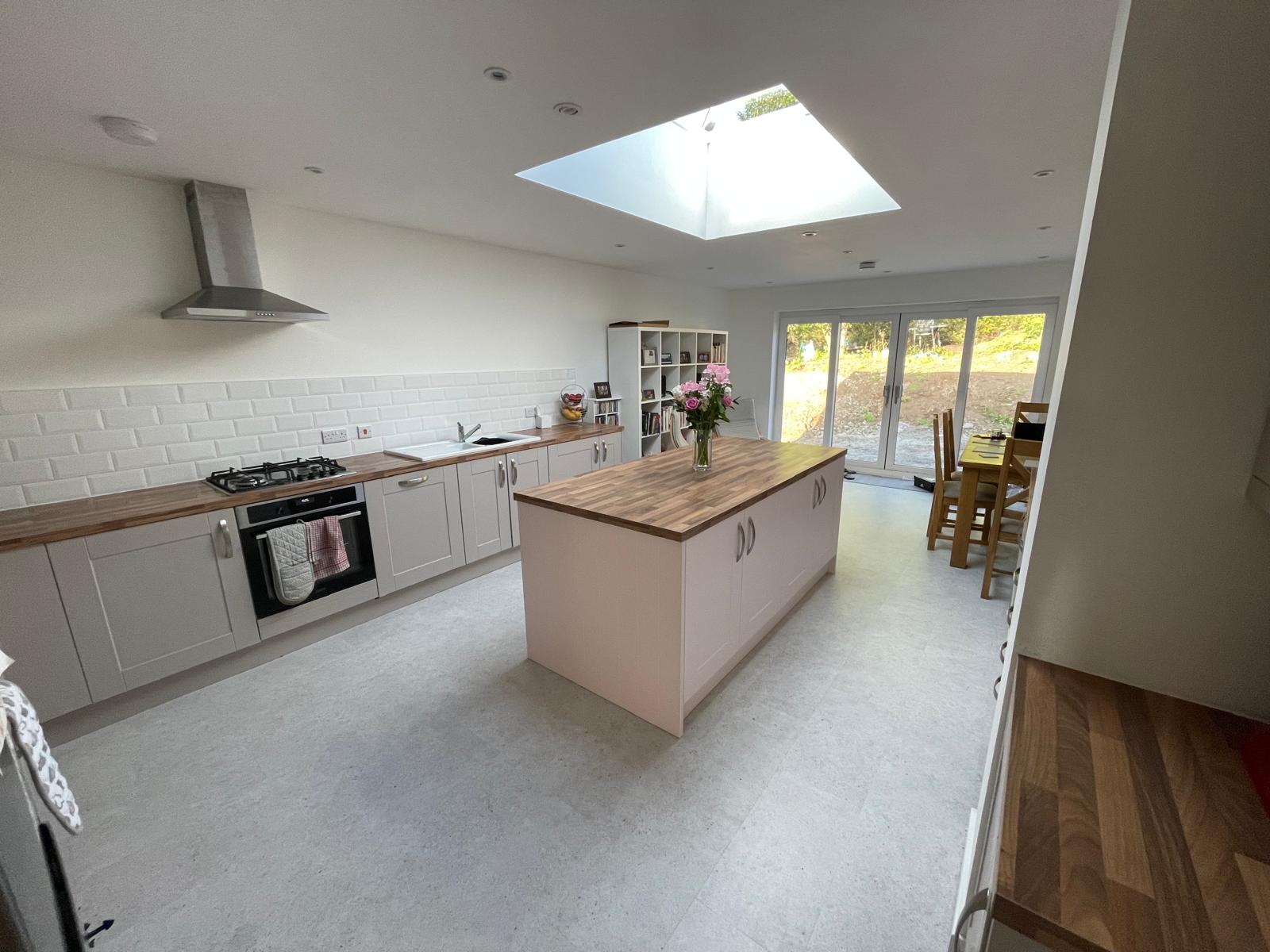 Light kitchen extension with skylight and island