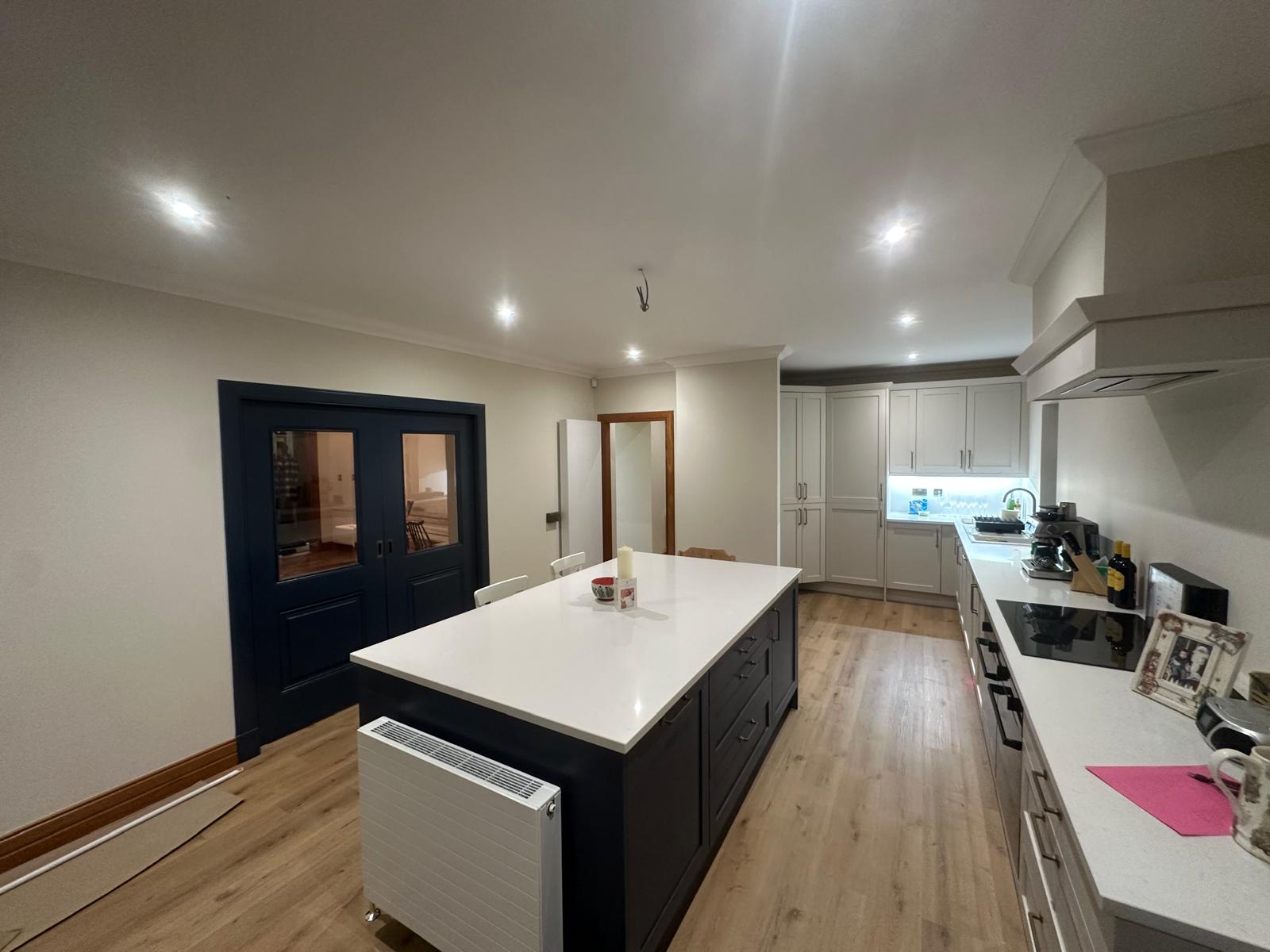 Navy island kitchen with white units