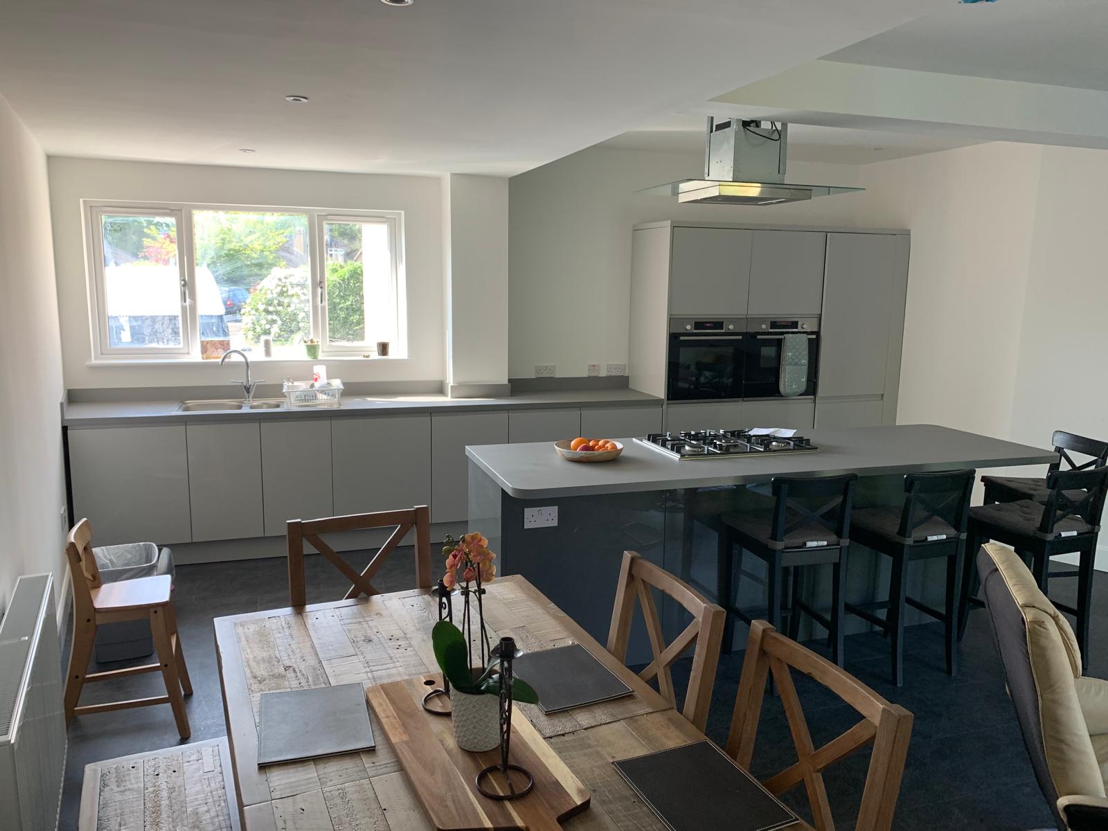 Grey kitchen diner with island and dining table