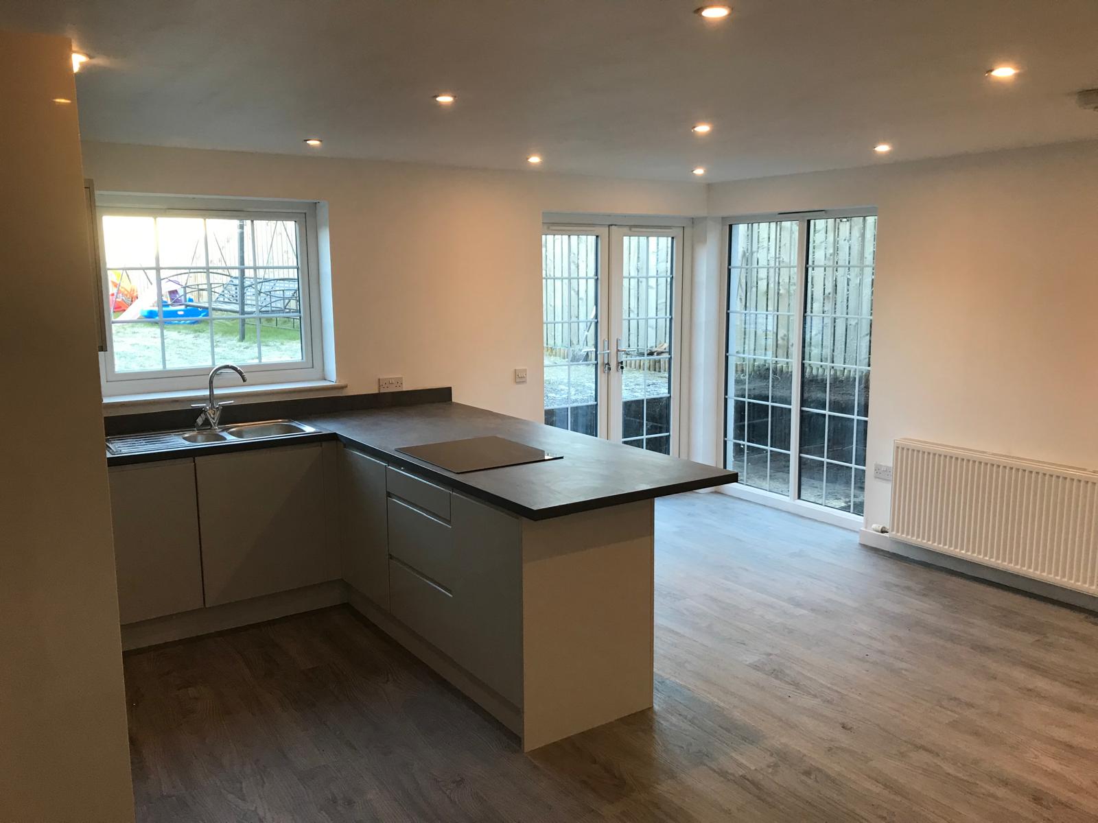 Contemporary kitchen with peninsula and french doors