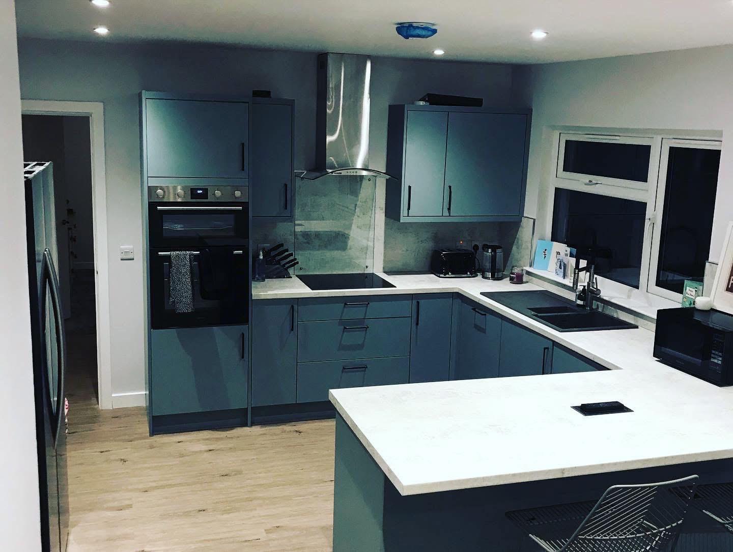 Blue kitchen with white marble worktops