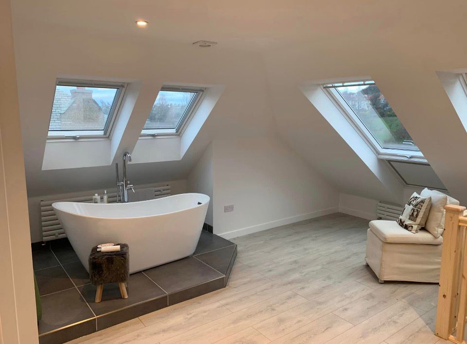 Loft bathroom with freestanding bath and Velux windows