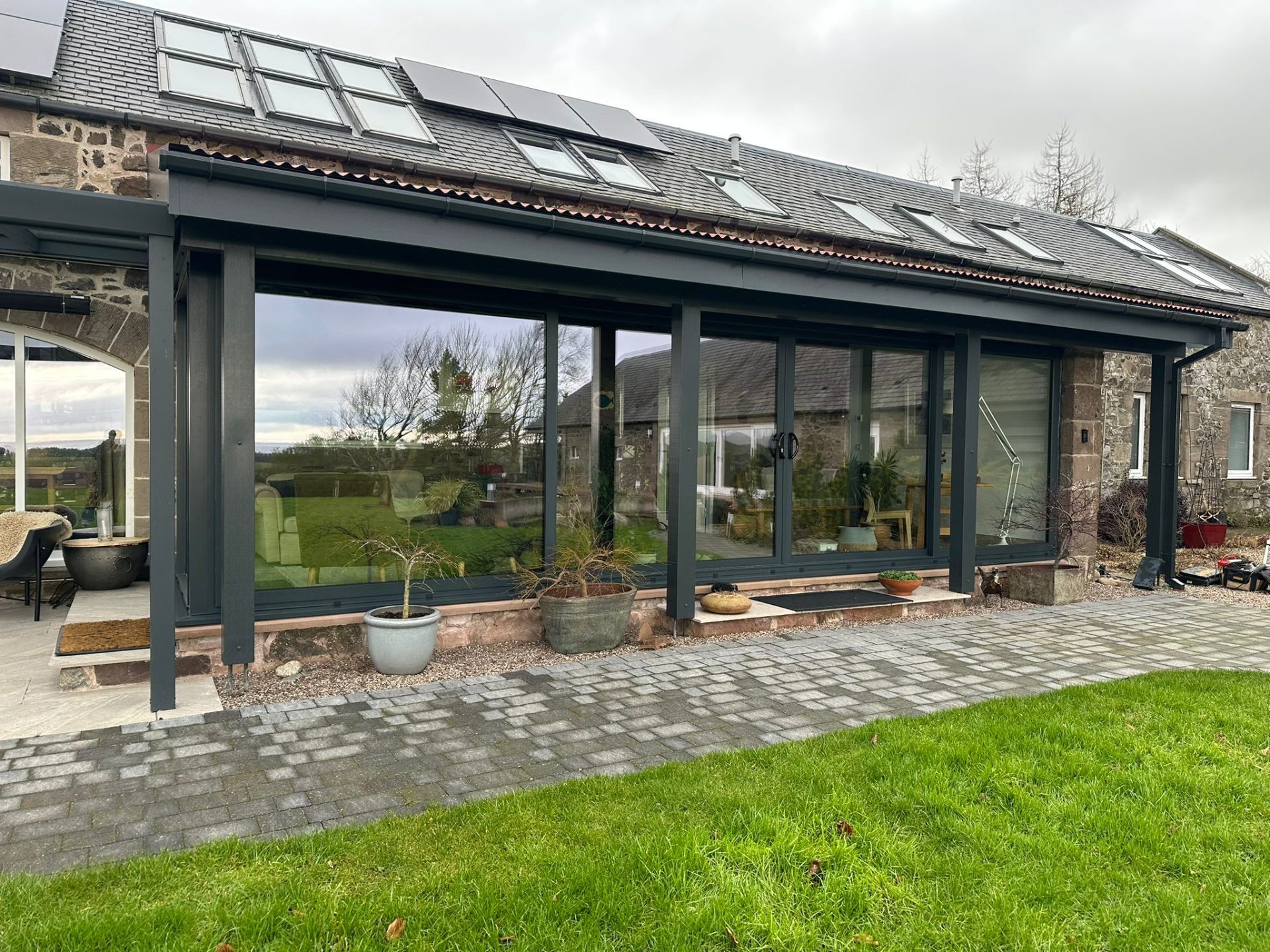 Full-length sliding doors with solar panels and skylights